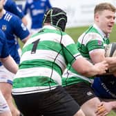 Donal Conroy of Naas looks for support to lay off his pass while being tackled
