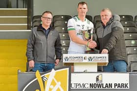 Huw Lawlor accepting the trophy after O'Loughlin's win in the Senior league final