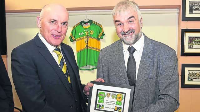 Stephen McCahill presents Anthony Molloy with an award to mark the silver jubilee of Donegals 1992 All Ireland victory. Photo: John McConnell