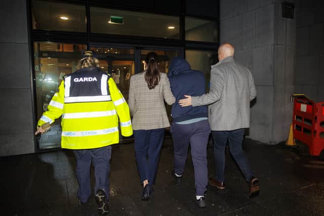 He wore navy joggers, navy hoodie and a black cap.