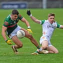 Mayo’s Tommy Conroy turns to win possession against Offaly's Cathal Ryan during the senior match which was in aid of Mayo Cancer Support. Pic Conor McKeown