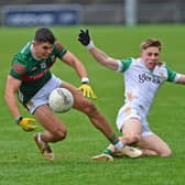 Mayo’s Tommy Conroy turns to win possession against Offaly's Cathal Ryan during the senior match which was in aid of Mayo Cancer Support. Pic Conor McKeown