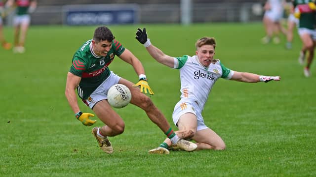 Mayo’s Tommy Conroy turns to win possession against Offaly's Cathal Ryan during the senior match which was in aid of Mayo Cancer Support. Pic Conor McKeown