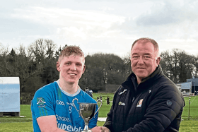 Graignamanagh captain Ivan Bolger is presented with the trophy by Paddy Cooney, chairman Kilkenny Junior Board