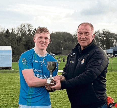 Graignamanagh captain Ivan Bolger is presented with the trophy by Paddy Cooney, chairman Kilkenny Junior Board