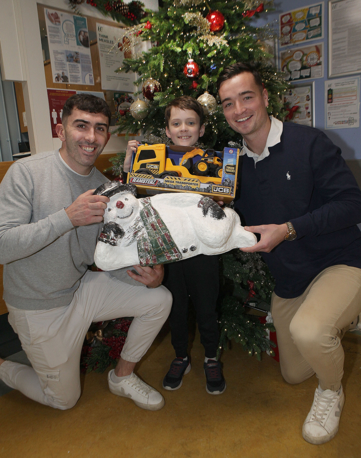 Four ice cool customers: Hurling stars Aaron Gillane and Kyle Hayes gift a truck and digger to Nathan Gleeson, Raheen, during a visit to the Children's Ark in UHL I PICTURE: Dave Gaynor