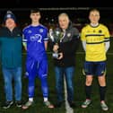 Don Gillespie presenting Andrew Gillespie (Rambo) Cup to Charlie McCleery, Trojans. Included, Don Boscos captain Caleb O'Doherty with on left Raymond Carton, Trojans FC.