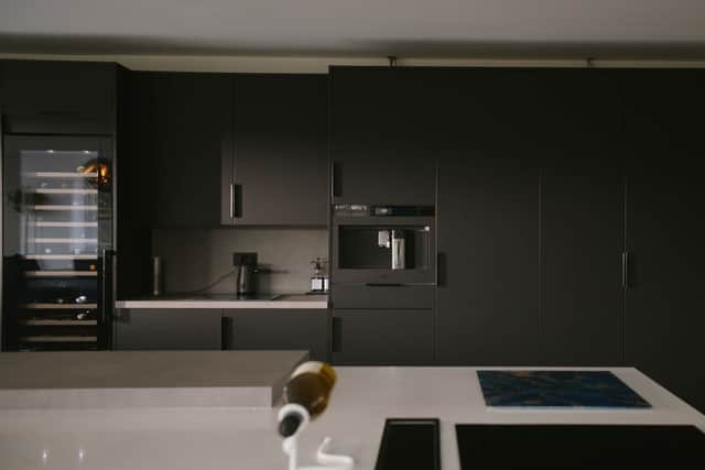 She says appliances, sinks, and taps often serve this purpose, and might be a range cooker framed by a decorative mantel; or an elegant ceramic Belfast sink paired with a classic tap.