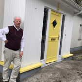 Tom Roche outside his home in Rhode
