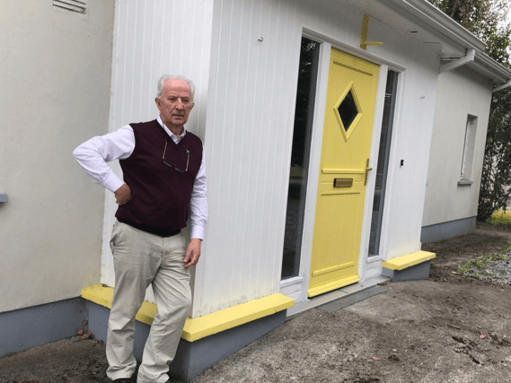 Tom Roche outside his home in Rhode