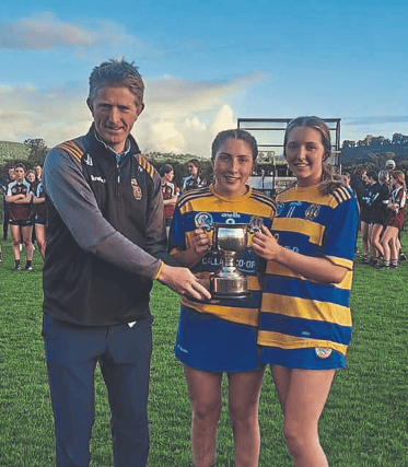John Lockes joint captains Rachel Phelan and Aisling O’Sullivan are presented with the minor Roinn A silverware