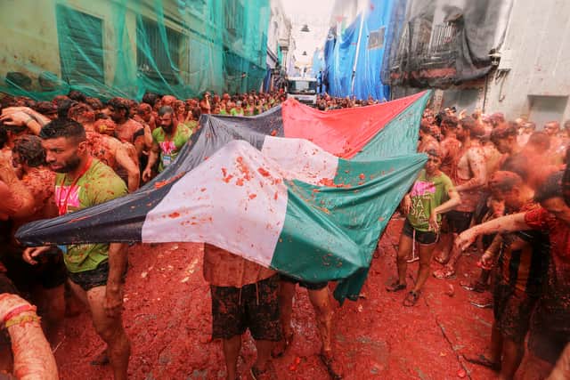 Tons of overripe tomatoes become projectiles in Spain’s Tomatina food fight