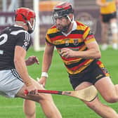 Ardclough Drew Costello side steps the in-rushing Tadhg Forde Maynooth during the 2025 UPMC Senior Hurling Championship round 2 game, Photo by Sean Brilly