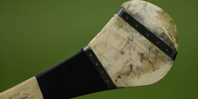 The man smashed a door of a car using a hurley.