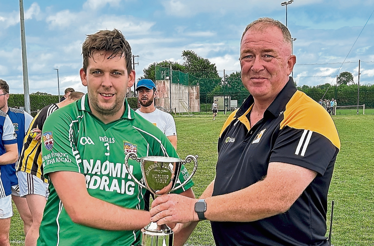 St Lachtain’s captain Darragh Quinn receives the Junior F League trophy from  Pat Cooney.  Picture: Willie Dempsey