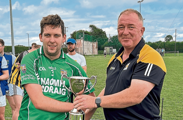 St Lachtain’s captain Darragh Quinn receives the Junior F League trophy from Pat Cooney. Picture: Willie Dempsey