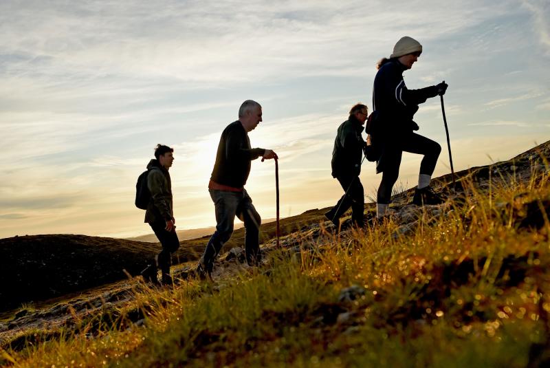 The sun rises behind pilgrims climbing Croagh Patrick for Reek Sunday 2024 (Pic: Conor McKeown)