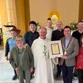 Mayor   McGuinness presents Fr Jim Murphy with a certificate to mark his achievements