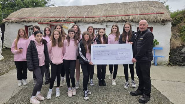 Sixth class pupils from Scoil Chroi Naofa, formerly St Patrick’s Girls School in Carndonagh, pictured presenting Pat Doherty from Doagh Island famine village with a cheque from a bake sale