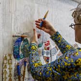 Lorna Donlon at work on the exhibition tapestry
