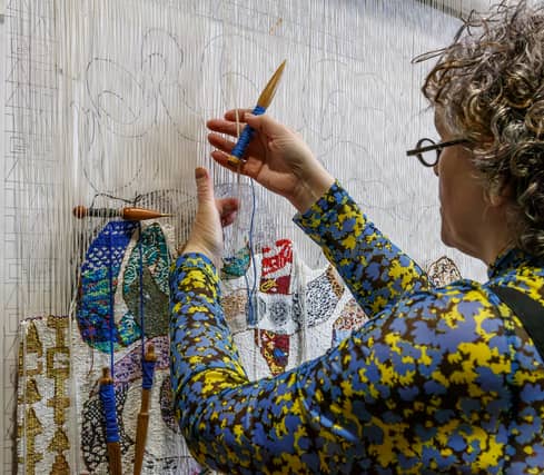 Lorna Donlon at work on the exhibition tapestry