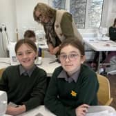Catherine McLaughlin and Lauren Doherty planning their textile artwork, with artist Bernie Murphy