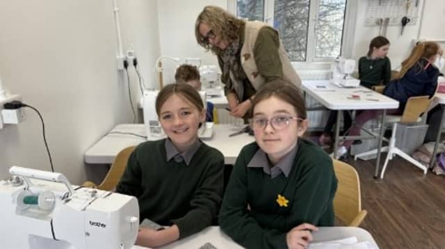 Catherine McLaughlin and Lauren Doherty planning their textile artwork, with artist Bernie Murphy