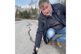 Cllr Pearse McGeogh at the damaged roads just outside Ardee where he was able to put his hand right into the wide cracks