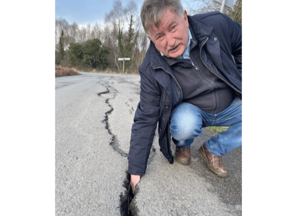 Cllr Pearse McGeogh at the damaged roads just outside Ardee where he was able to put his hand right into the wide cracks