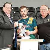 Threecastles captain Darragh Walsh receives the  Junior B championship trophy from Paul Kavanagh, JJ Kavanagh (sponsor) and Paddy Cooney, chairman Junior Board