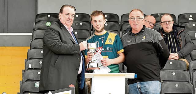 Threecastles captain Darragh Walsh receives the Junior B championship trophy from Paul Kavanagh, JJ Kavanagh (sponsor) and Paddy Cooney, chairman Junior Board