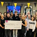 Ollie Harvey and Tina Higgins present the cheque for Greg Fitzgerald Recovery Fund to Greg's son Leon