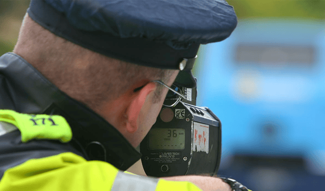 A Garda performs a speed check. (File photo)