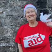 Lilian Webb hanging a 'Dove of Peace' on her Christmas tree