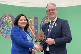 Principal Victoria Guinan presenting President of the GAA Jarlath Burns with a specially commissioned 4,600-year-old piece of local big yew.