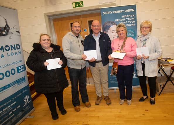 Gerry McMonagle, Derry Credit Union, presenting £25 prizewinners at Monday's AGM. From left Ciara O'Reilly, Sean-Paul Brinkley, Frances Meenan and Grace McKenna.