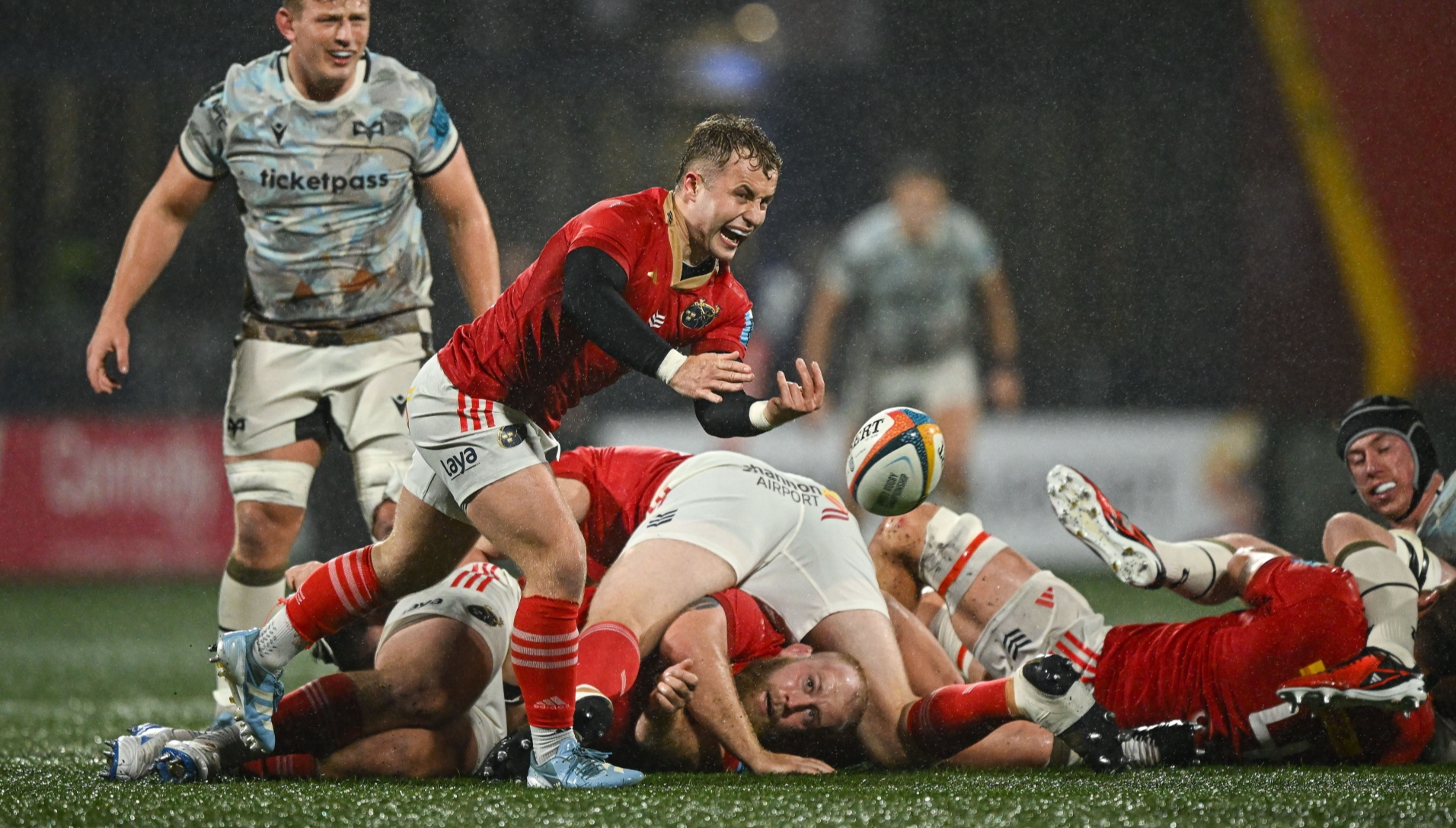 Craig Casey, of Munster Rugby, gets his pass away at a wet Virgin Media Park in their URC bonus point win over the Ospreys on Saturday evening