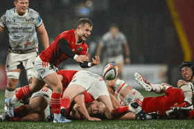 Craig Casey, of Munster Rugby, gets his pass away at a wet Virgin Media Park in their URC bonus point win over the Ospreys on Saturday evening
