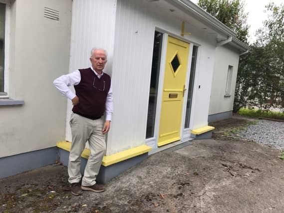 Tom Roche outside his home in Rhode