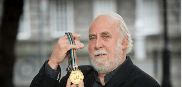 The late John Keating proudly displays the Gold Medal of Honour that he received at the Olympic Fine Arts 12 years ago