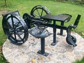 The John Smyth Memorial Seat made from a Pierce horse-drawn finger bar mower at the Forge in Windgap. It was installed by Windgap Tidy Towns and the local  community