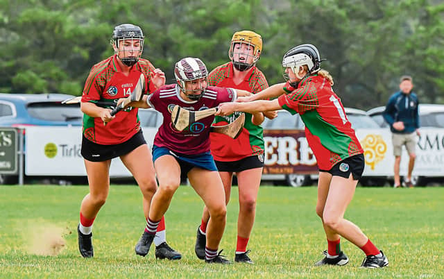 Caoimhe Dowling (Dicksboro) tries to clear her lines despite serious pressure during Sunday’s senior league/championship game in Palmerstown. Picture: Billy Culleton