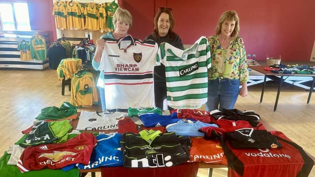 Mary and Imelda Maguire donating their late brother Dermot's jersey collection to Mairead Mulreany of Ardara GAA club. Photo: Clg Ard An Ratha