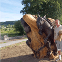Raymond Dowley and his dog Teddy standing beside the  sculpture of the griffins in Castle Park in Carrick-on-Suir. Picture Anne Marie Magorrian