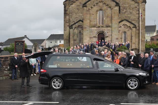 Mourners gathered in rain at the graveyard outside Donacavey Church of Ireland church in Fintona for a committal service on Wednesday afternoon.