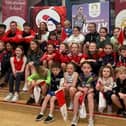 Kelly McGrory being welcomed home by children and athletes from Tír Chonaill AC