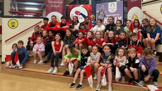Kelly McGrory being welcomed home by children and athletes from Tír Chonaill AC