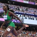Rhasidat Adeleke of Team Ireland, right, crosses the finish line to finish fourth in the women's 400m final at the Stade de France during the 2024 Paris Summer Olympic Games last night
