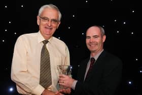 Eamon Harvey is presented with his Outstanding Coach award by Pat Ryan, Director of Development and Coaching at Athletics Ireland in 2018