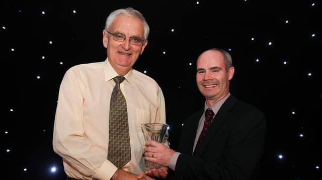Eamon Harvey is presented with his Outstanding Coach award by Pat Ryan, Director of Development and Coaching at Athletics Ireland in 2018